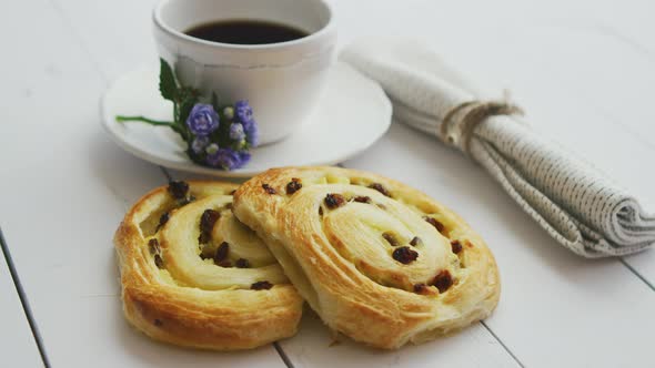 Delicious Pastry with Raisins and a Cup of Coffee Top View.