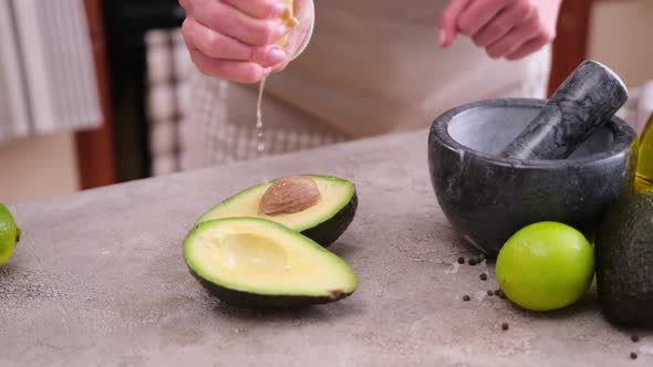 Guacamole Ingredients  Avocados Whole and Cut on Concrete Table with a Marble Mortar
