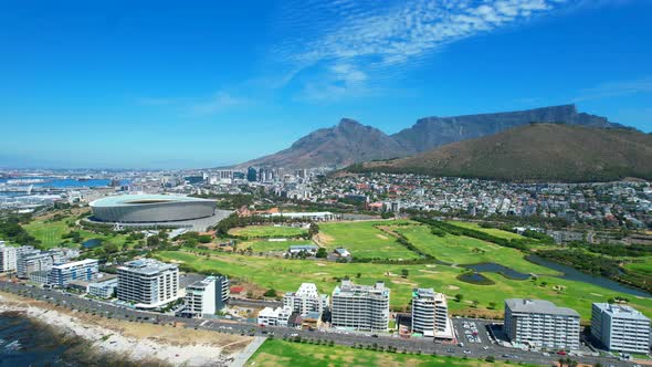 Sunny day in Green Point, Cape Town with coastline view of golf course and stadium, aerial