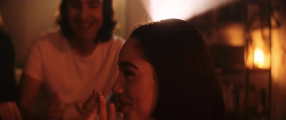 Young woman loaughs while eating a slice of pizza