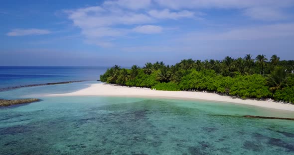 Luxury above clean view of a sandy white paradise beach and blue ocean background in colourful 4K