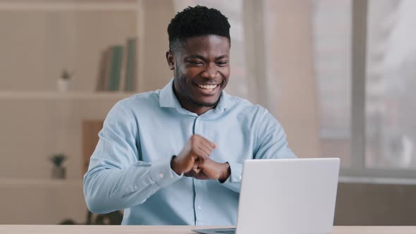 Excited African Young Man Happy American Businessman Manager Working Remote on Laptop Computer Win