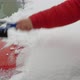 Cleans Car Hood with Brush From Snow and Rain in Winter - VideoHive Item for Sale