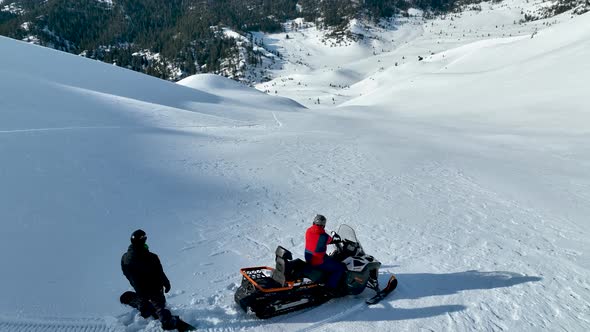 Snowmobile high in the mountains aerial view 4 K