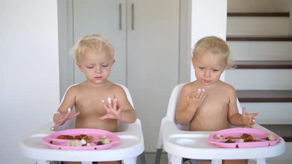 Twin Sisters Enjoying Their Vegan Dessert Licking the Cream of Their Little Fingers While Lunching