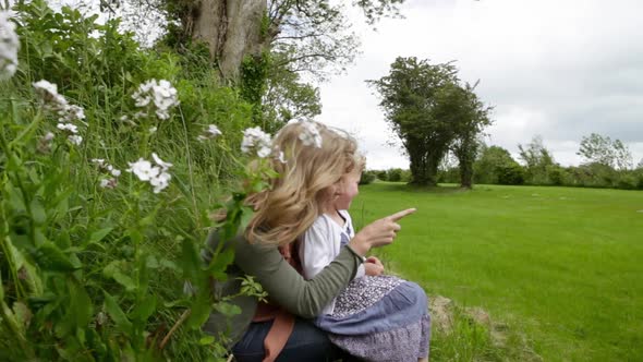 Young Woman and Daughter Looking Across Field