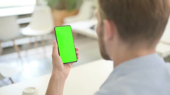 Young Creative Man Using Smartphone with Chroma Screen