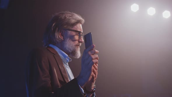 Man Showing the New Design of the Smartphone