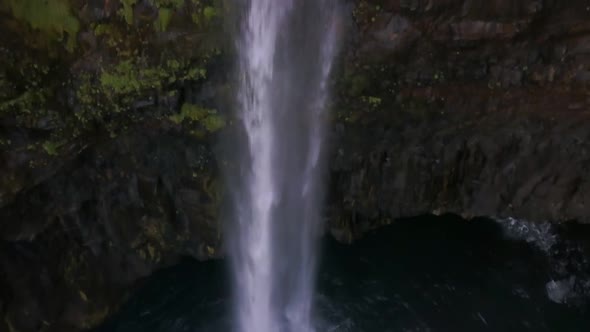 Small Waterfall Falls Into the Sea From the Cliffs