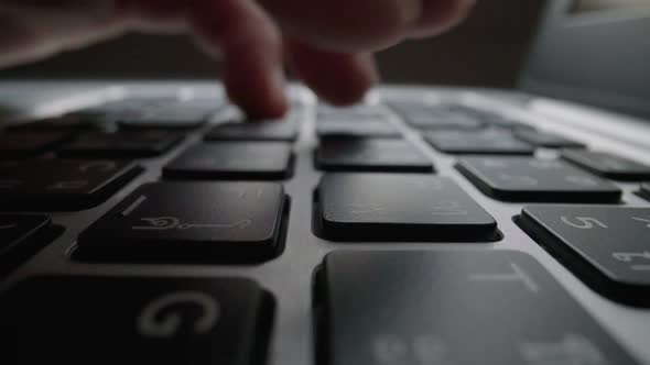 Closeup Typing on Keyboard with Man Fingers