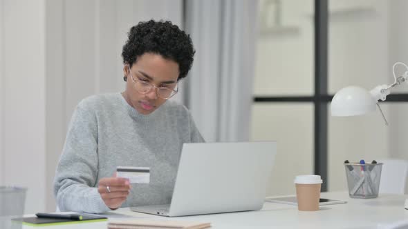 African Woman Upset By Online Payment Failure on Laptop