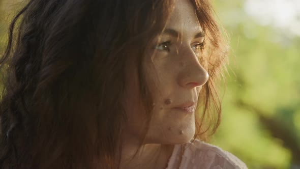 Pivoting Around Close Up Portrait of a Young Adult Curly Caucasian Woman Looking at Camera