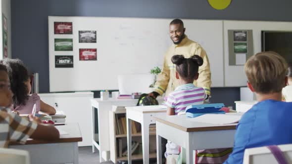 Video of happy african american teacher with class of diverse pupils during ohs lesson