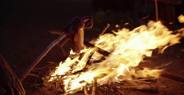 Meat being prepared at a bonfire