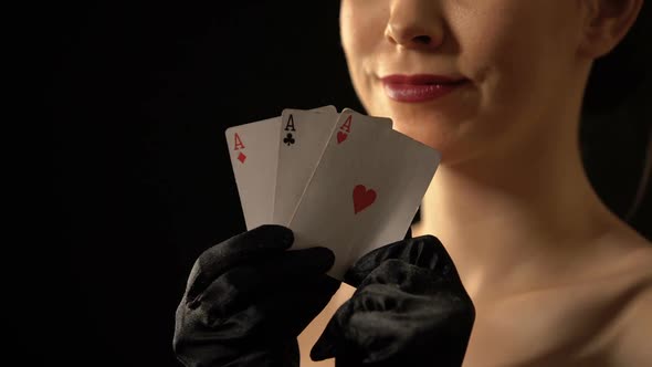 Smiling Lady Showing Three of Aces Into Camera, Poker Combination, Winner