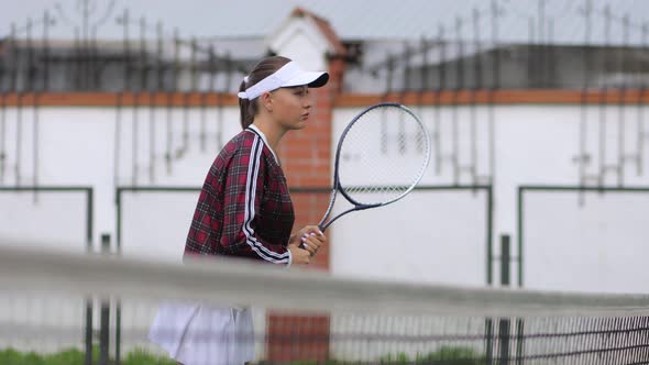 Seductive Confident Woman Playing Tennis on Court