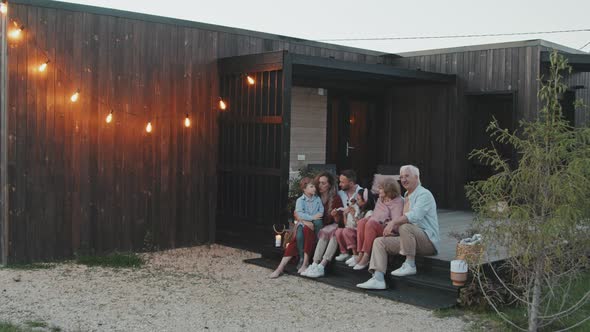 Big Family Sitting on Porch