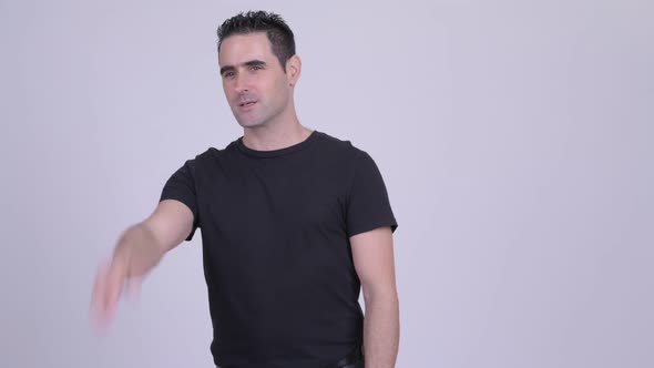 Handsome Man Explaining Something Against White Background