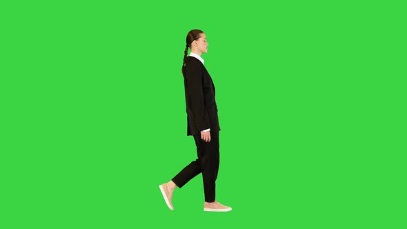 Young Woman in Office Suit Walking Adjusting Her Jacket on a Green Screen Chroma Key