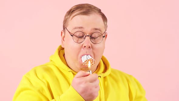 Obese Man with Mouth Full of Cigarettes Trying To Smoke It All at the Same Time, Slow Motion.