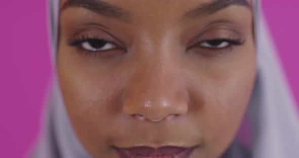 Close Up Shot of Young Modern Muslim Afro Beauty Wearing Traditional Islamic Clothes on Plastic Pink