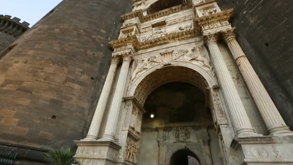 Tourist photographing and walking to Maschio Angioino castle in Naples, Italy