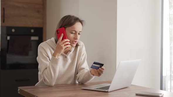 Upset Young Woman Using Online Banking Service Problem with Blocked Credit Card Using Laptop