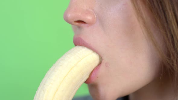 Unrecognizable Young Woman Eating Banana