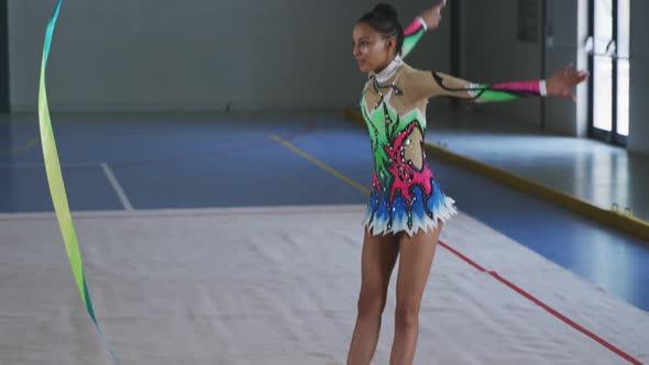 Female gymnast performing at sports hall