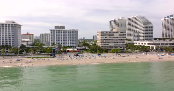 Black Chevy Suburban Limo Cruising Fort Lauderdale Beach. 5k Aerial Lateral Video