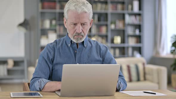 Old Man Working on Laptop