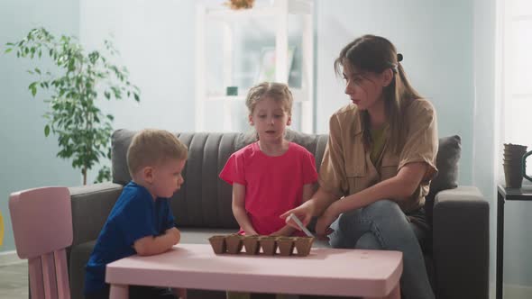 Young Woman with Children in Room are Home Gardening