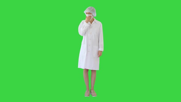 Coughing Female Doctor in a Mask To Prevent Others From Infection on a Green Screen, Chroma Key