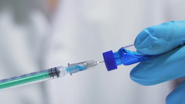 Doctor Picks Up a Syringe for Coronavirus Vaccine