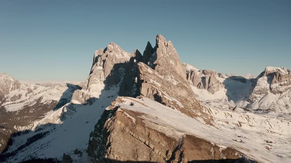 Low cinematic drone shot towards Seceda mountain ridge in the Dolomites