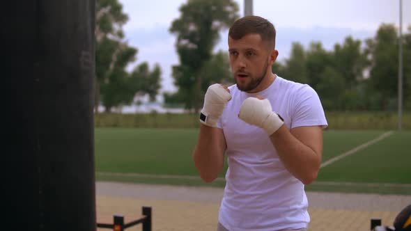 Man Using His Strength To Punch a Punchbag