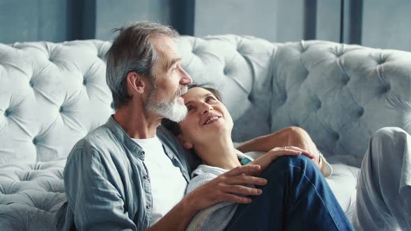 Elderly Couple Sitting Near the Sofa