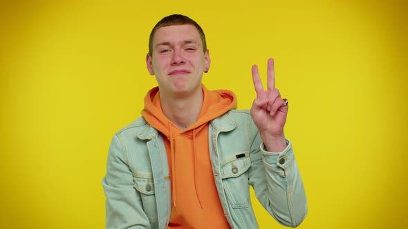 Handsome Stylish Smiling Man Showing Victory Sign Hoping for Success and Win Doing Peace Gesture