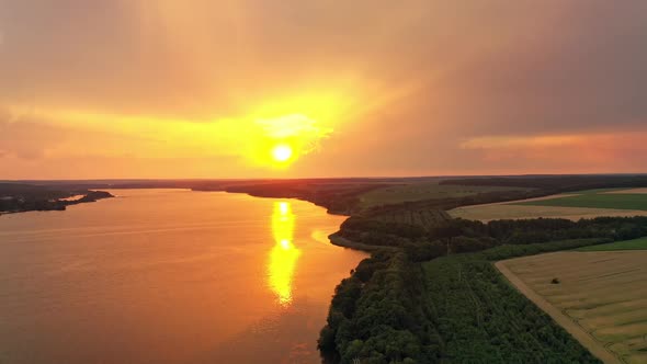 Fantastic view of yellow sun reflecting on the water surface at sunset.