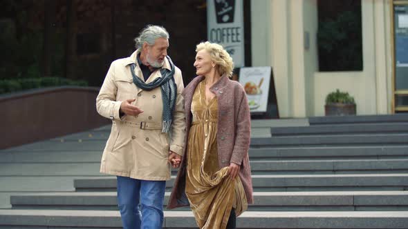 Elderly Couple Walking on the Street