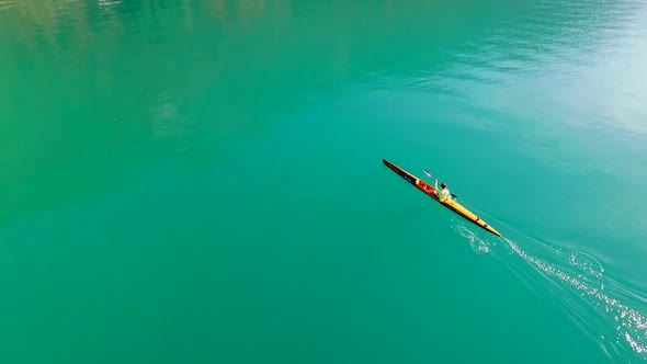 A kayaker paddles in a scenic mountain lake.