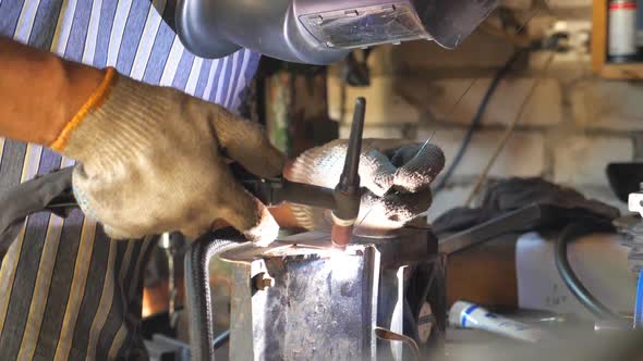 Close Up Processing of Welding Metal Parts in Garage, Mechanic or Welder Using Welding Machine 