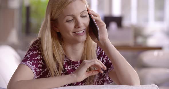 Beautiful Blonde Woman Relaxing on Couch Having a Call