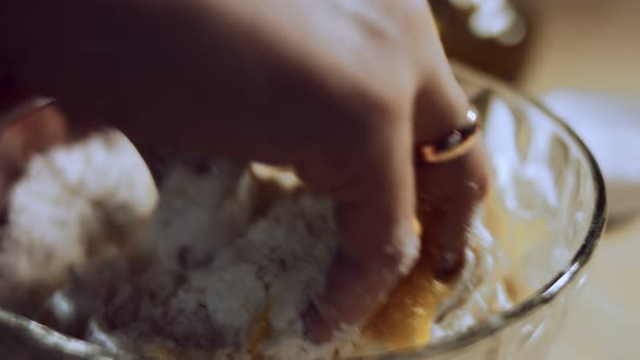 Closeup Female Hand Mixing Food Ingredients in Glass Bowl