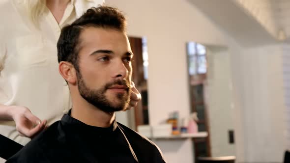 Female hairdresser interacting with man