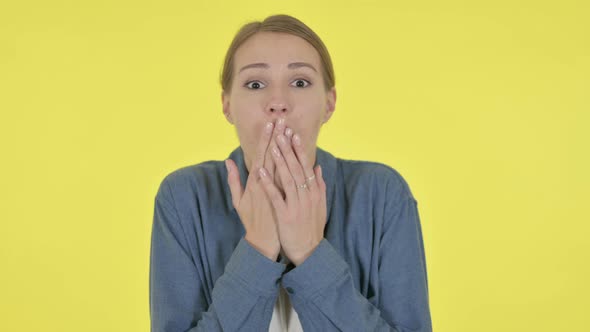 Young Woman Feeling Shocked on Yellow Background