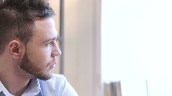 Thinking Pensive Man Looking Through Window