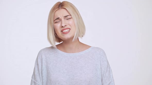 Totally Disappointed Young Beautiful Blonde Girl Over White Background Slow Motion