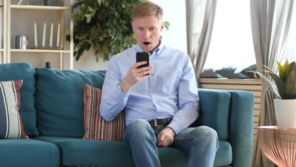 Shocked Astonished Middle Aged Man Using Smartphone