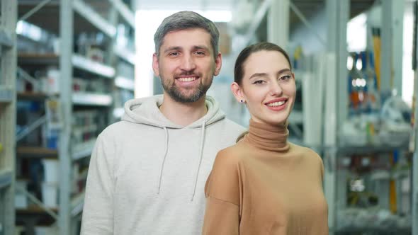 Portrait of Happy Young Satisfied Couple Posing in Hardware Store Indoors